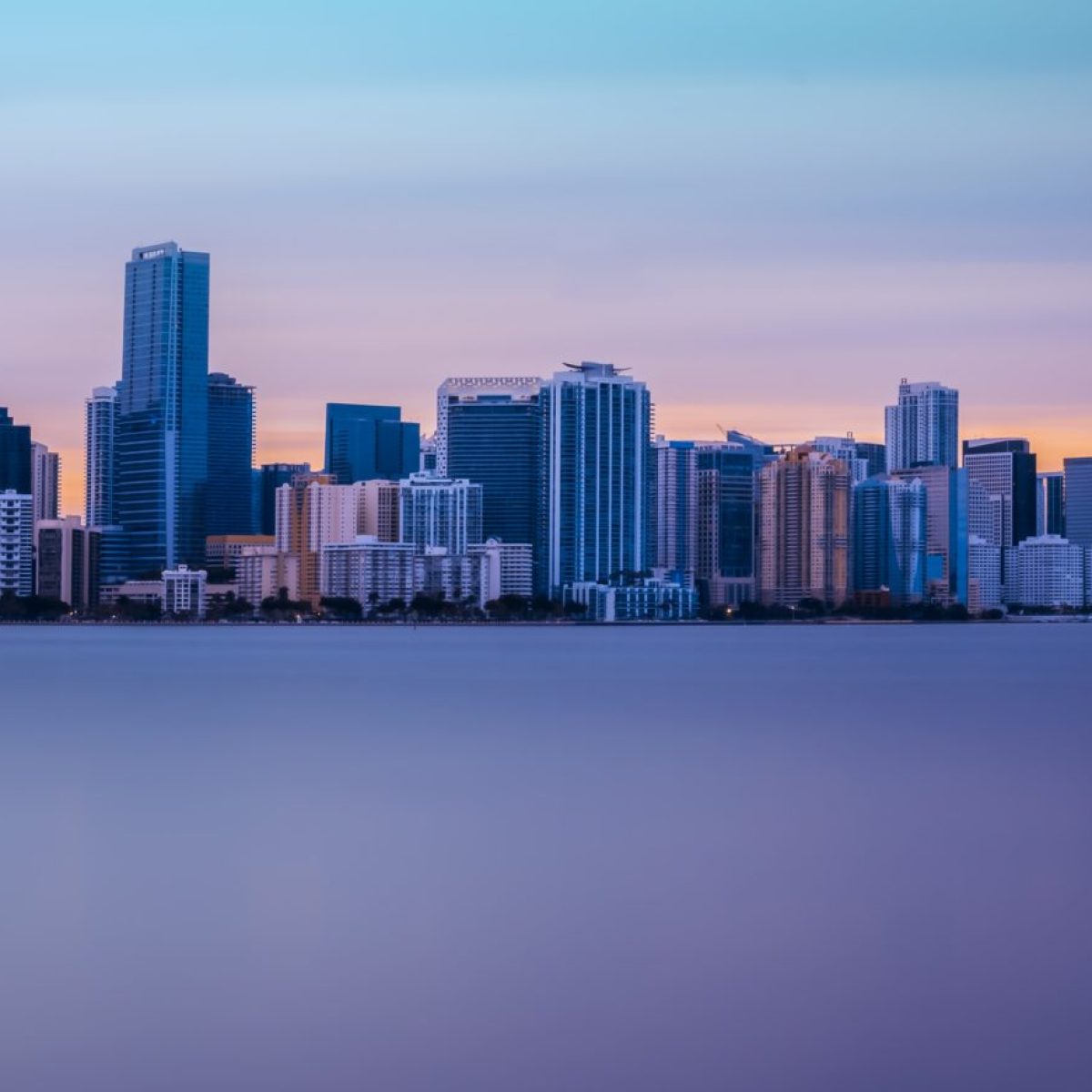 a large body of water with a city in the background