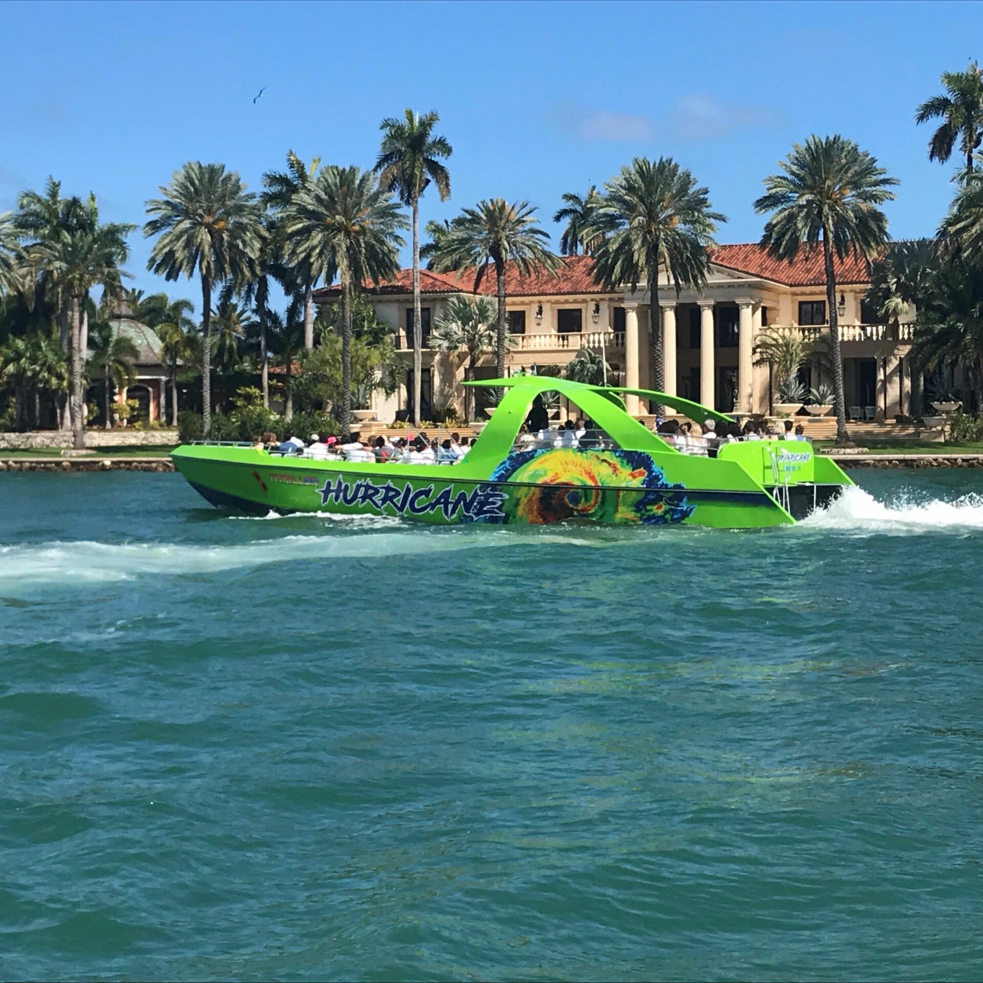 a green boat on a body of water